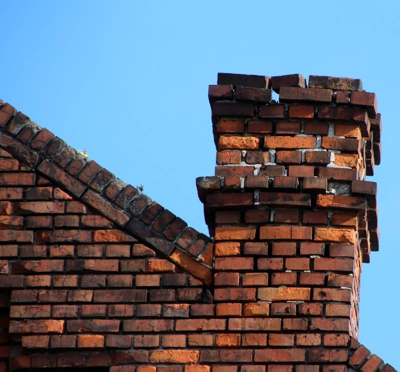 Damaged chimney on an Alva home showing cracks and missing mortar